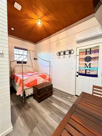 a bed sitting in a bedroom next to a window