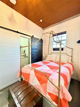 a bedroom with a bed and a mirror