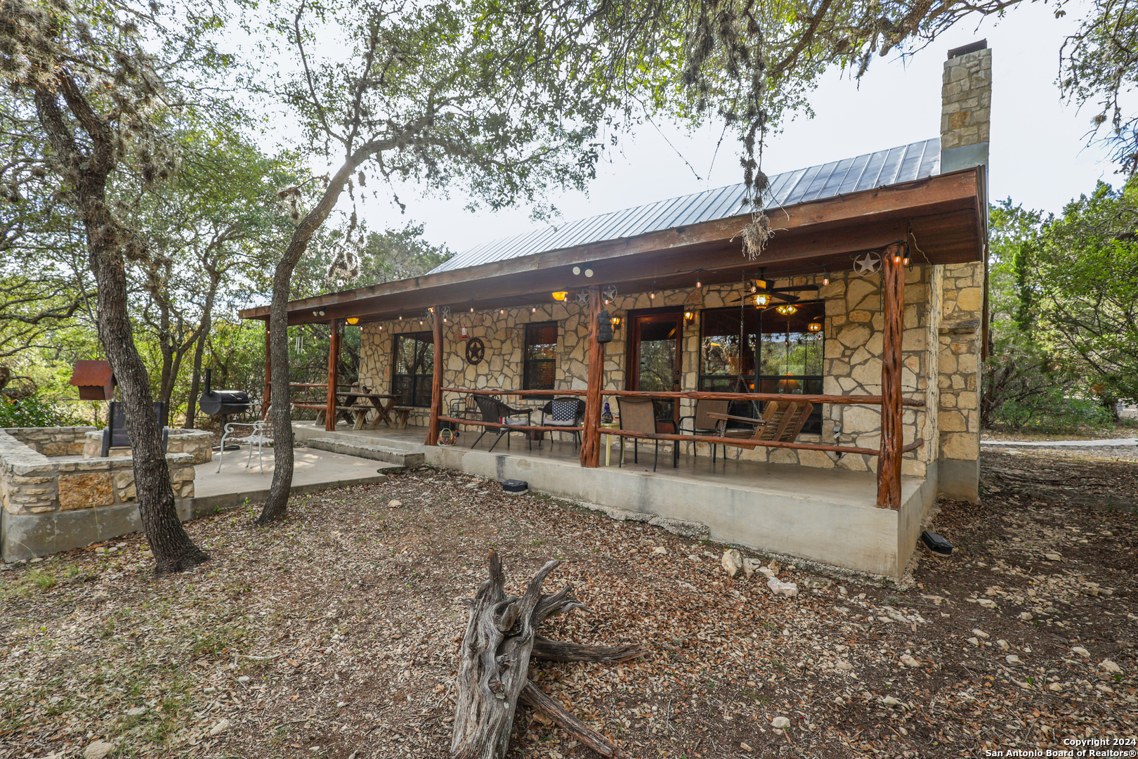 1177 River Road Concan, TX 78838 - Photo 27 of 34 a view of a patio with a table and chairs under an umbrella