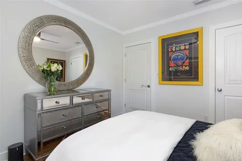 a bedroom with a bed and a mirror