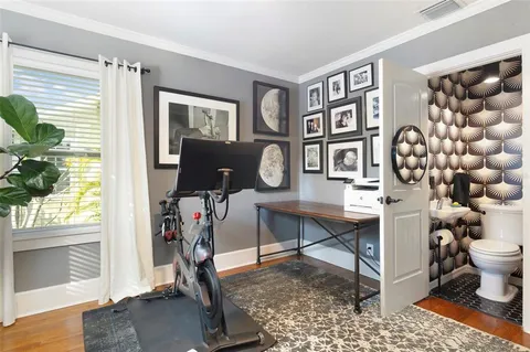 a view of workspace with wooden floor windows and book shelf