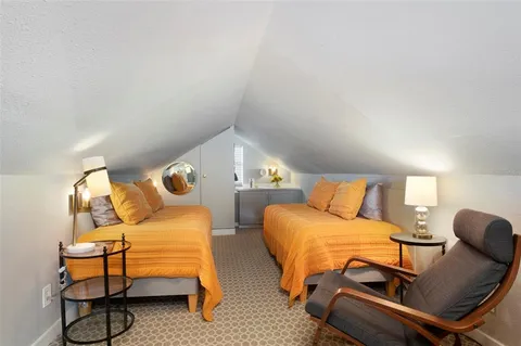 a bedroom with furniture and a chair