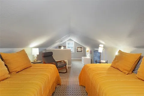 a bedroom with a bed and window