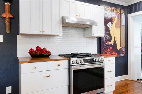 a kitchen with stainless steel appliances granite countertop a stove and a microwave