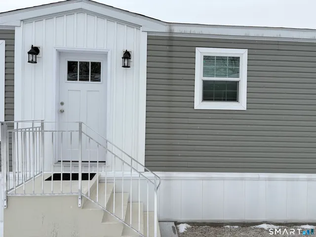 a view of balcony with white wall and stairs