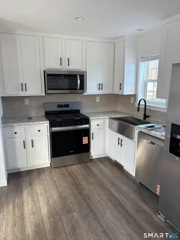 a view of washer and dryer with wooden floor