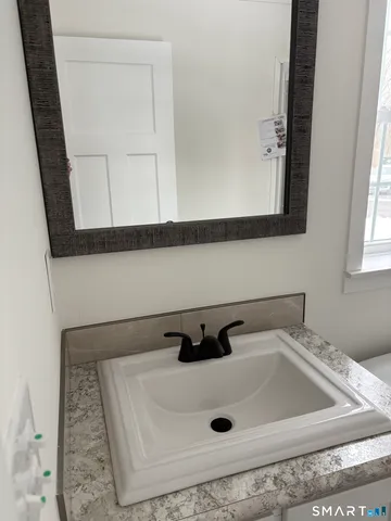 a white toilet sitting next to a shower