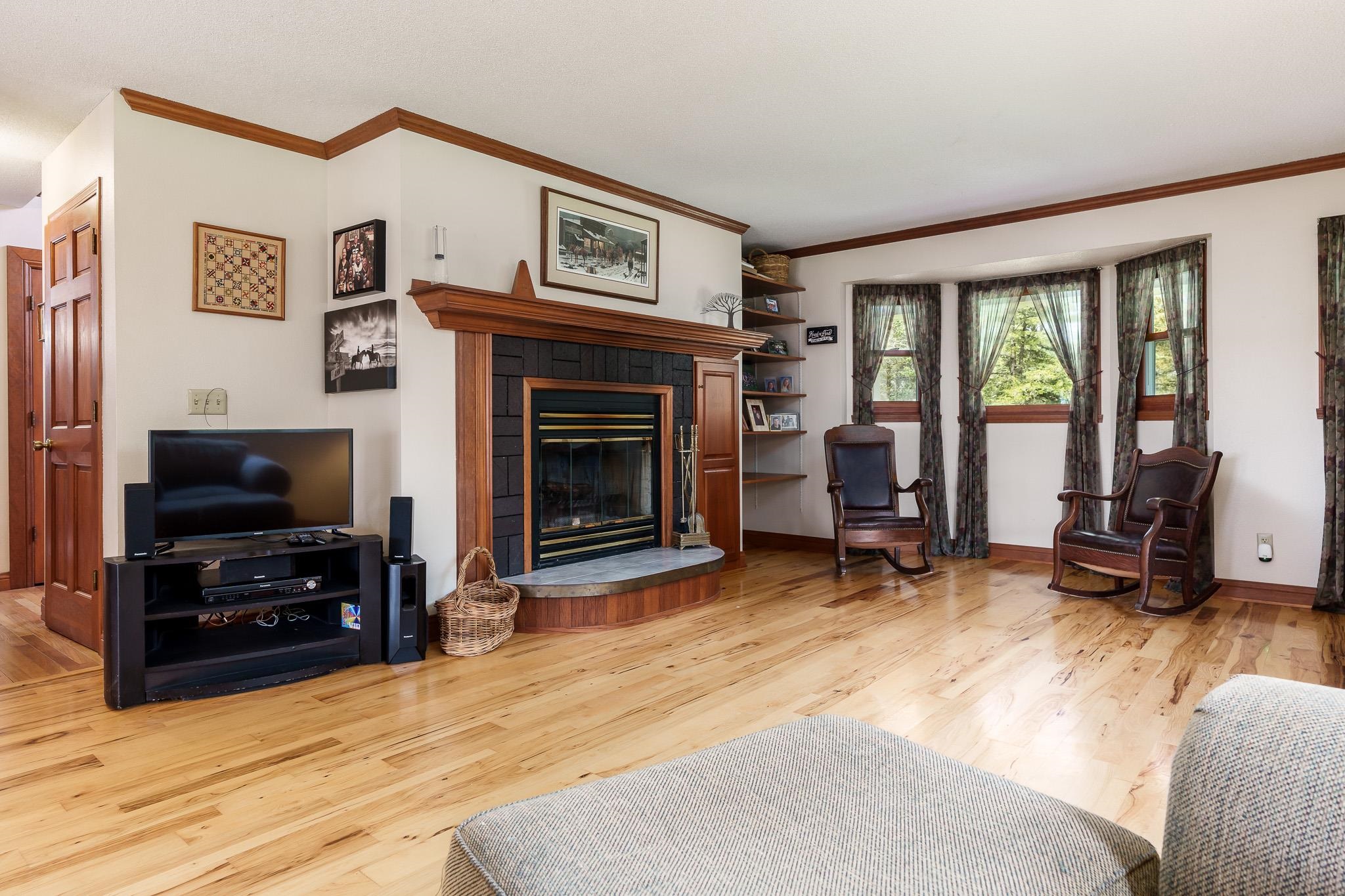 14795 Hansberry Road Rockton, IL 61072 - Photo 13 of 32 a living room with furniture a flat screen tv and a fireplace