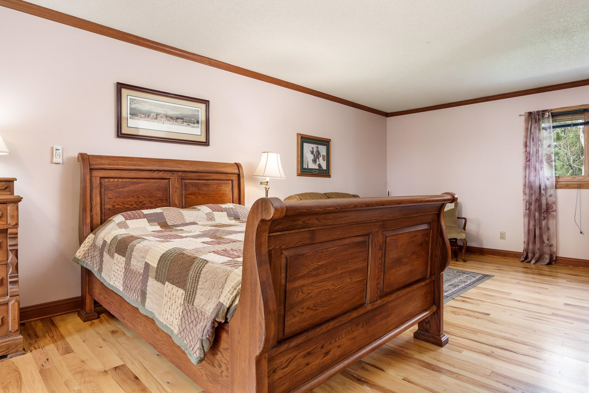 14795 Hansberry Road Rockton, IL 61072 - Photo 21 of 32 a bedroom with a bed and wooden floor