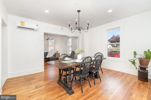 a view of a a dining room with furniture window and wooden floor