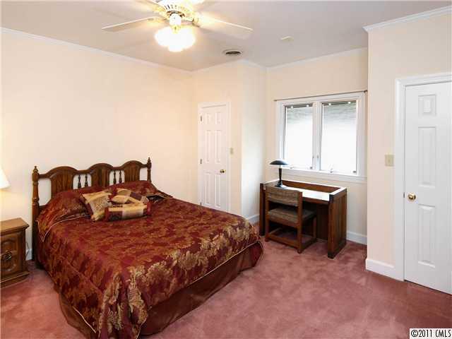 2653 Farmlake Lane Fort Mill, SC 29708 - Photo 12 of 16 a bedroom with a bed and a chandelier