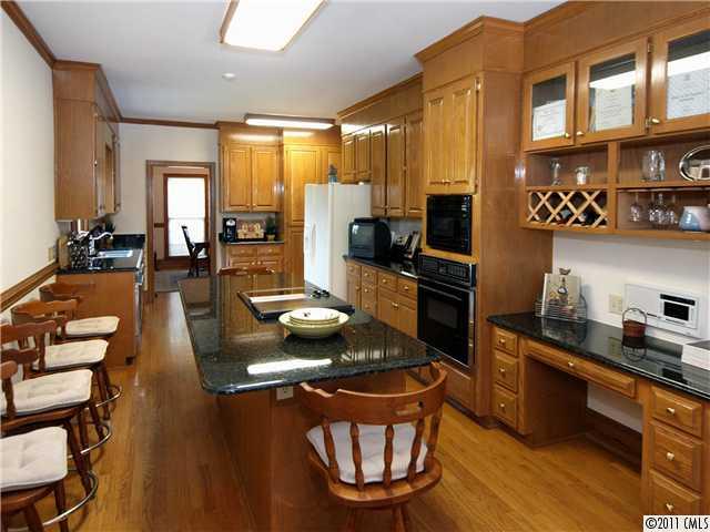 2653 Farmlake Lane Fort Mill, SC 29708 - Photo 6 of 16 a kitchen with sink refrigerator and dining table