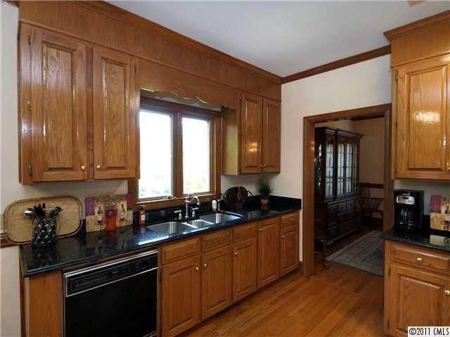 2653 Farmlake Lane Fort Mill, SC 29708 - Photo 7 of 16 a kitchen with granite countertop wooden cabinets and a sink