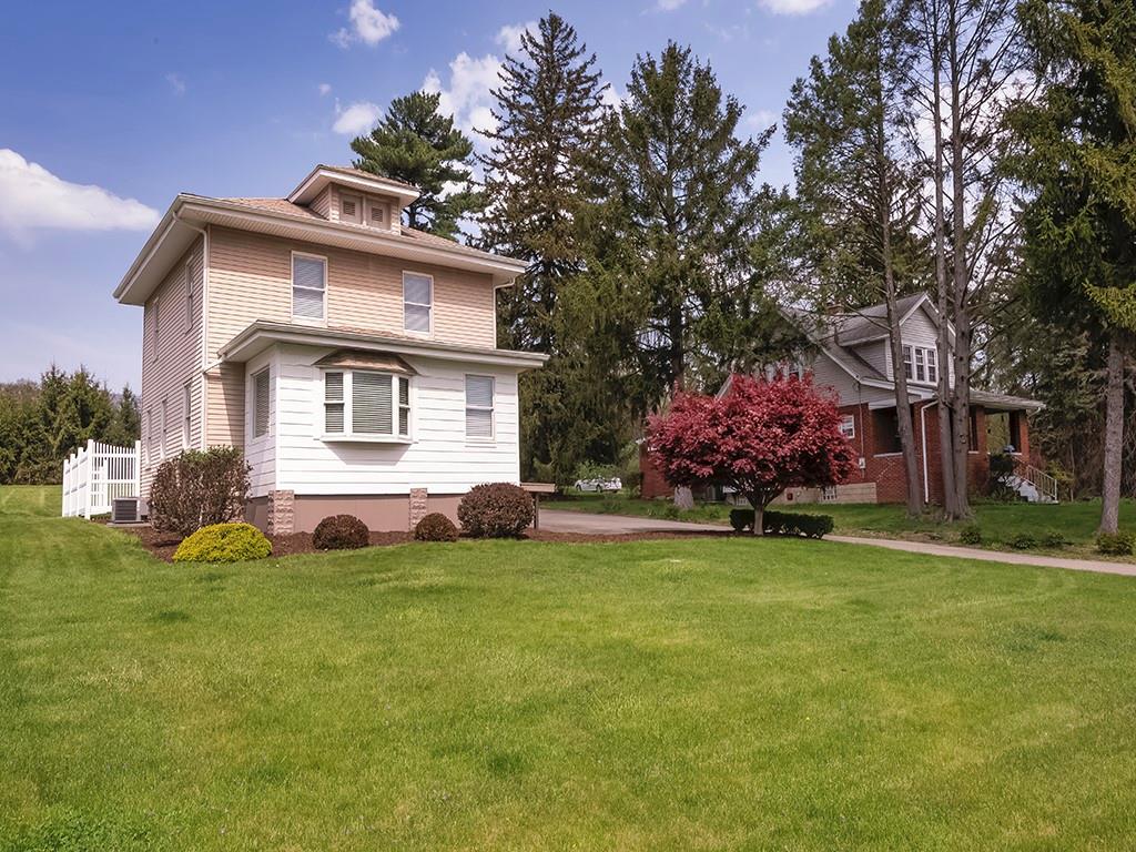 9151 Peebles Road Allison Park, PA 15101 - Photo 1 of 28 a front view of a house with a garden and trees