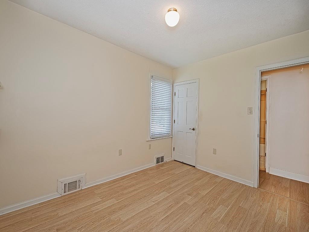 9151 Peebles Road Allison Park, PA 15101 - Photo 22 of 28 an empty room with wooden floor and white walls