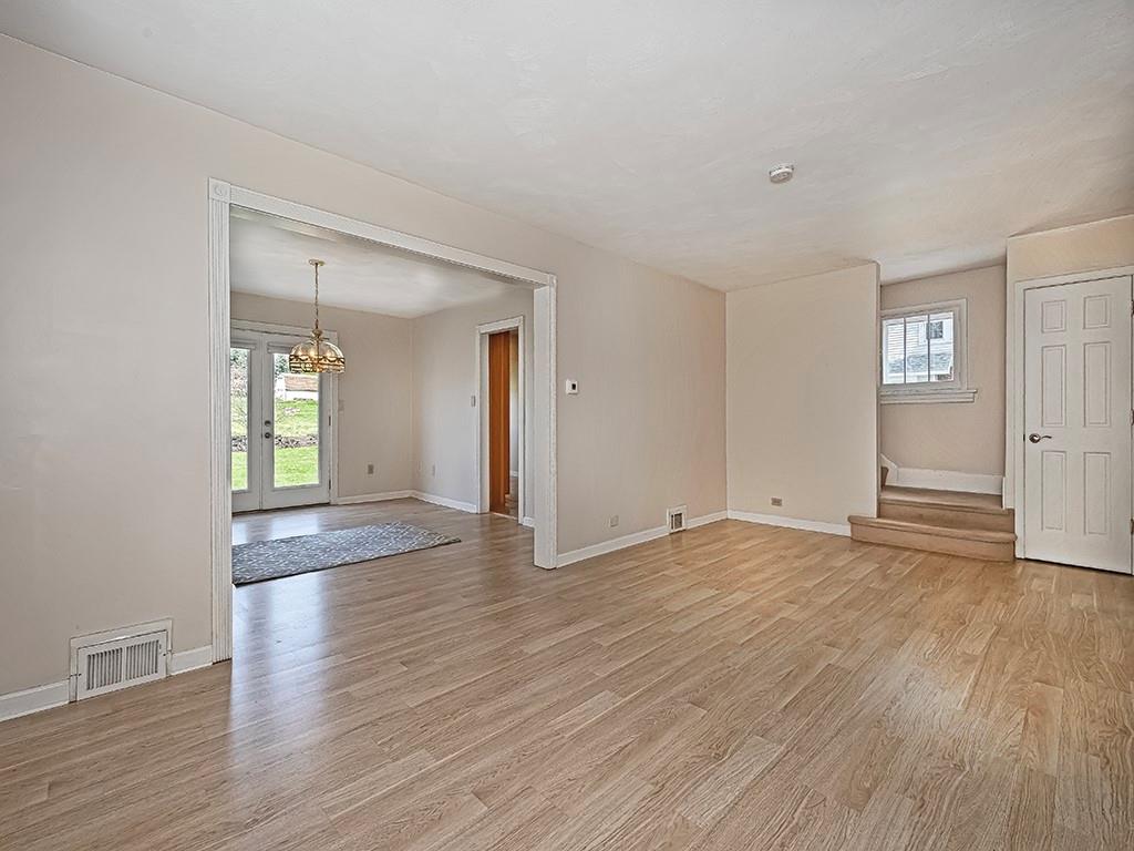 9151 Peebles Road Allison Park, PA 15101 - Photo 4 of 28 an empty room with wooden floor and windows