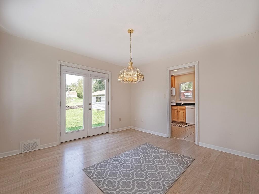 9151 Peebles Road Allison Park, PA 15101 - Photo 7 of 28 an empty room with windows and chandelier
