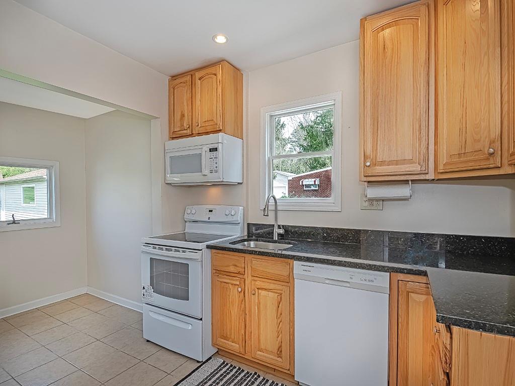 9151 Peebles Road Allison Park, PA 15101 - Photo 9 of 28 a kitchen with granite countertop white cabinets and white appliances