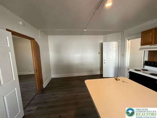 a bathroom with a granite countertop sink and a toilet