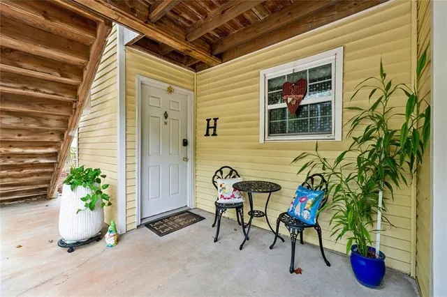 a couple of table and potted plant in front of a door