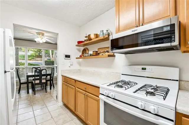 a kitchen with a stove and white cabinets