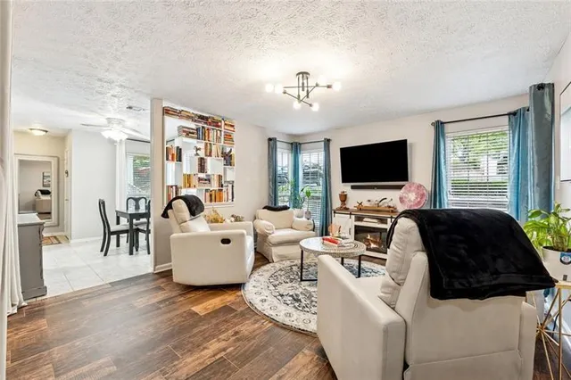 a living room with furniture a flat screen tv and a fireplace