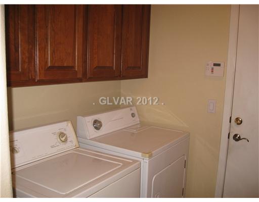 2290 Lyrical Road Henderson, NV 89052 - Photo 24 of 25 Other. Extra cabinets provide additional laundry room storage, and the door to the garage would reveal a workbench and additional shelving.