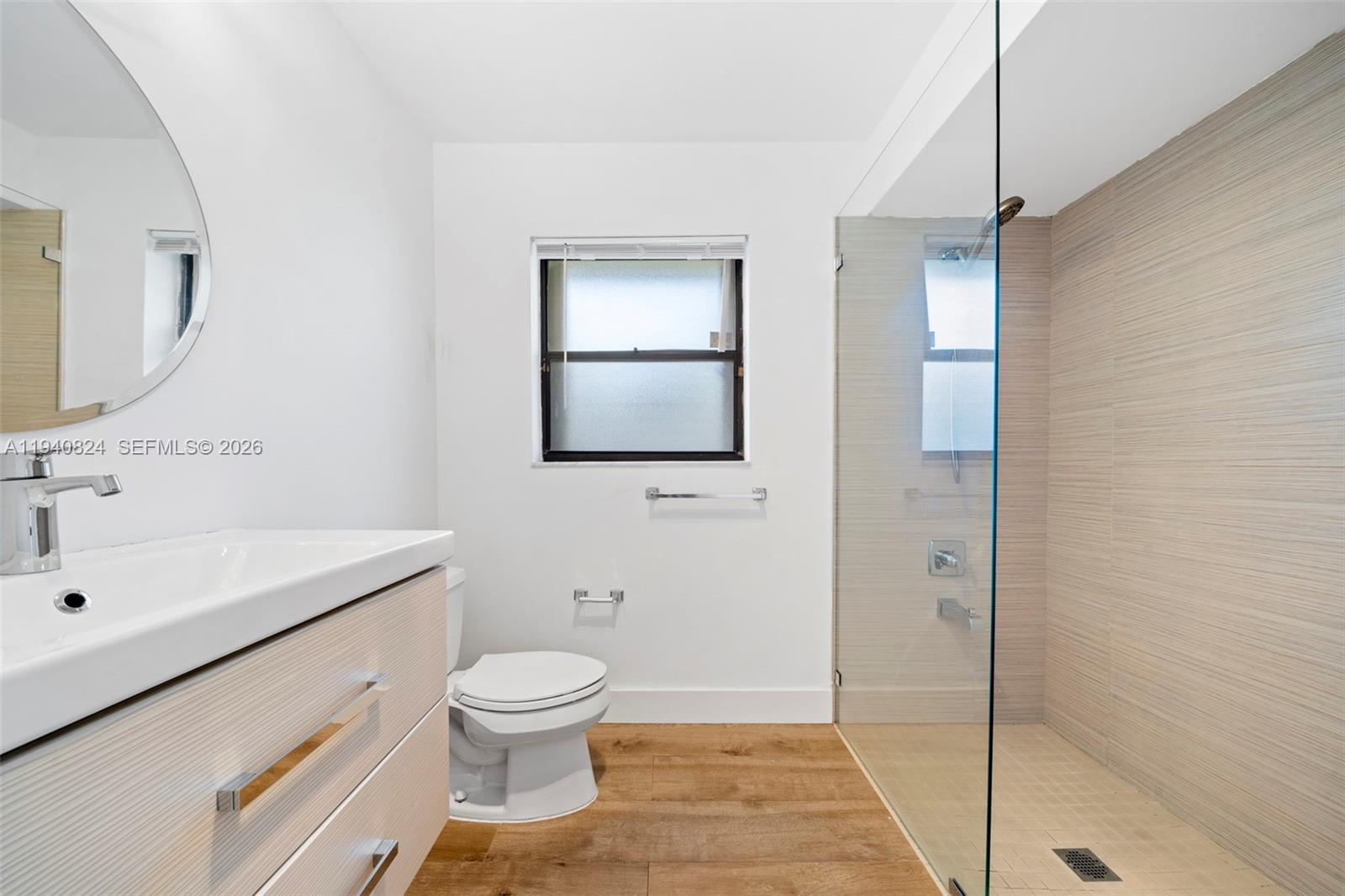 10424 Southwest 114th Court Miami, FL 33176 - Photo 11 of 23 a bathroom with a sink toilet a mirror and shower