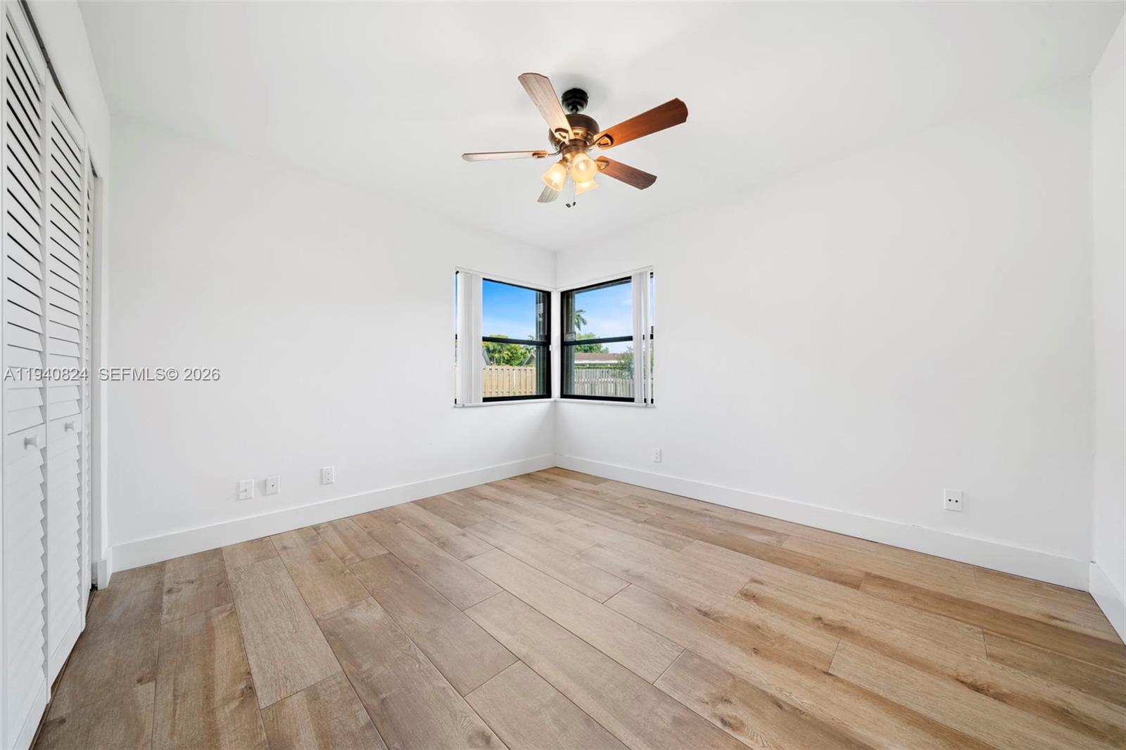 10424 Southwest 114th Court Miami, FL 33176 - Photo 13 of 23 an empty room with wooden floor fan and windows