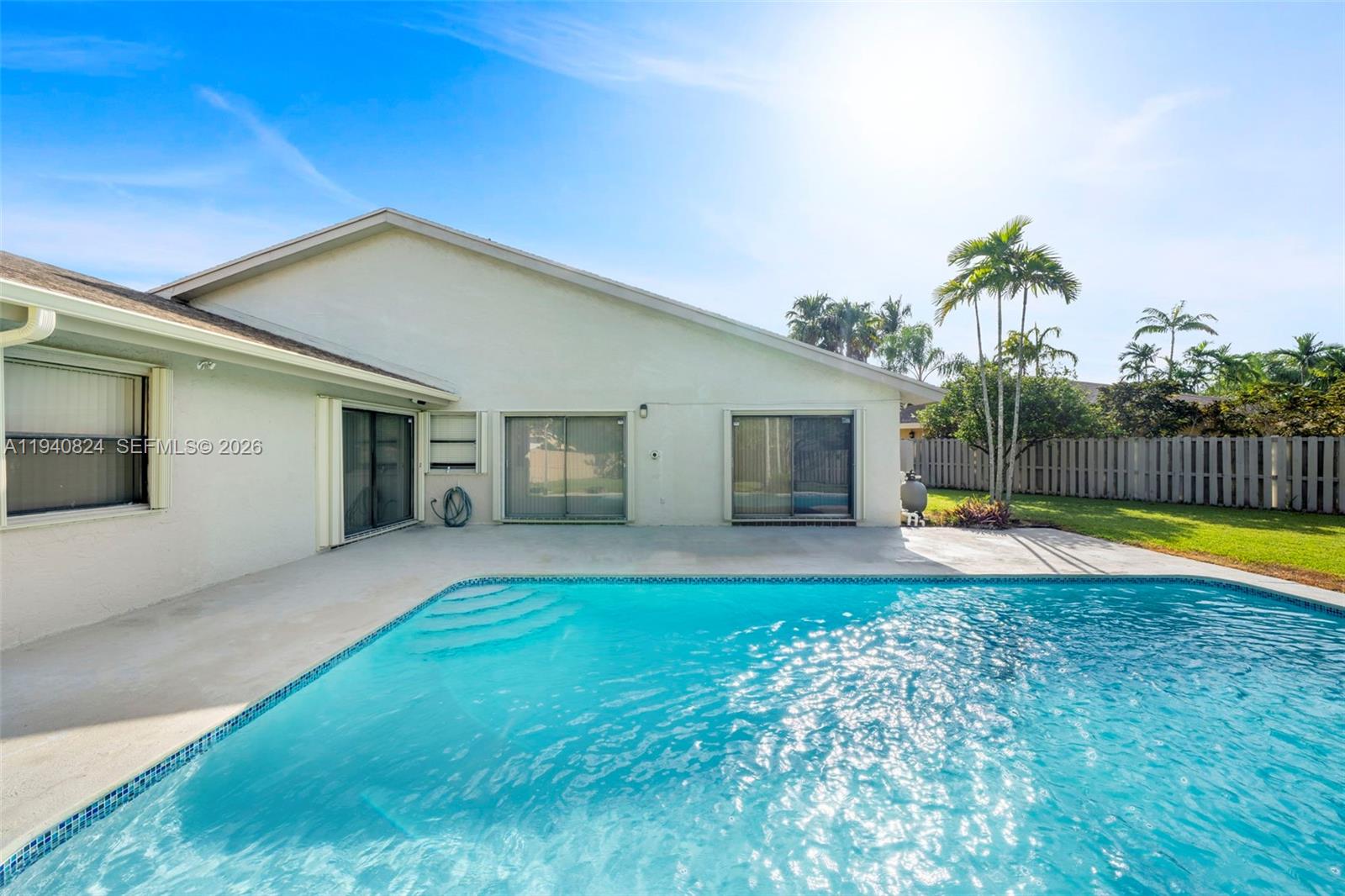 10424 Southwest 114th Court Miami, FL 33176 - Photo 23 of 23 a view of a house with swimming pool and a yard