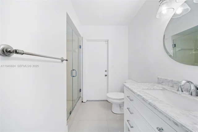 a bathroom with a sink toilet a mirror and shower