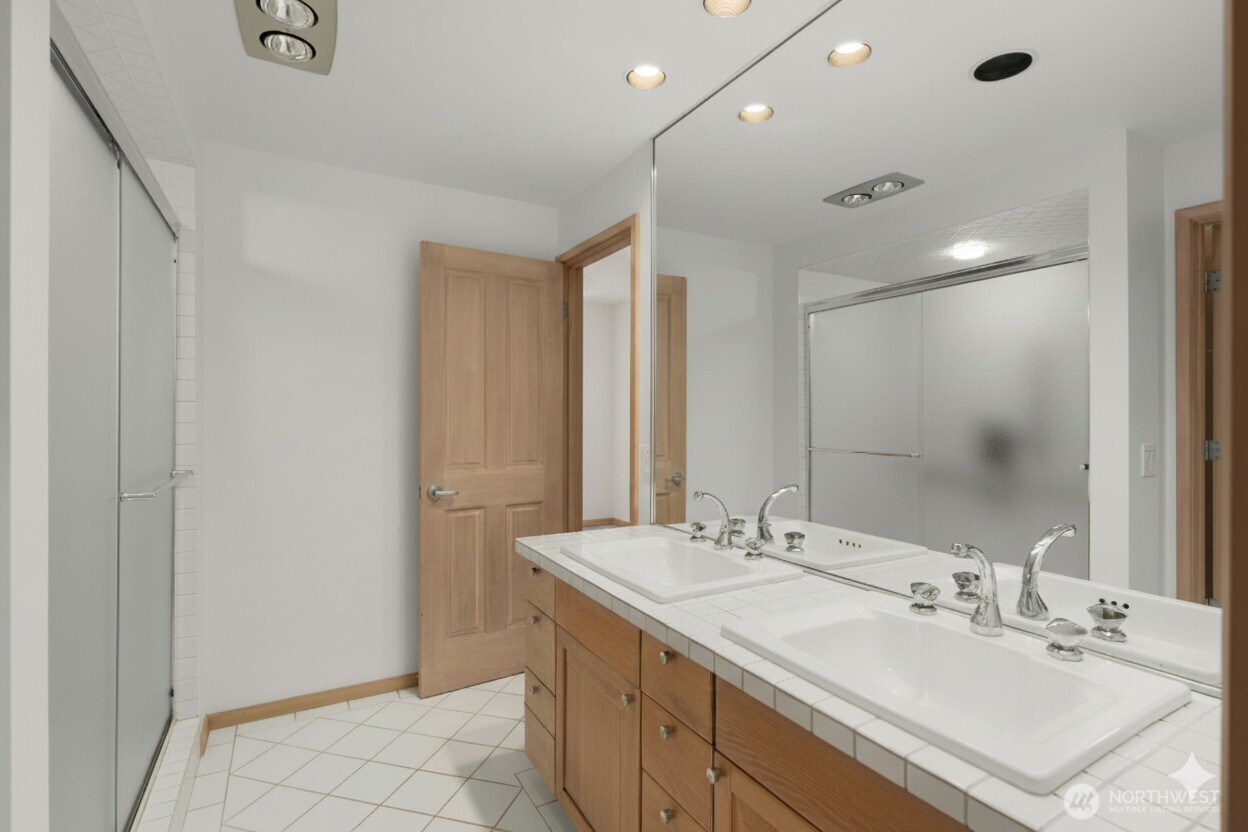 8428 North Mercer Way Mercer Island, WA 98040 - Photo 24 of 40 a bathroom with a sink double vanity and a mirror