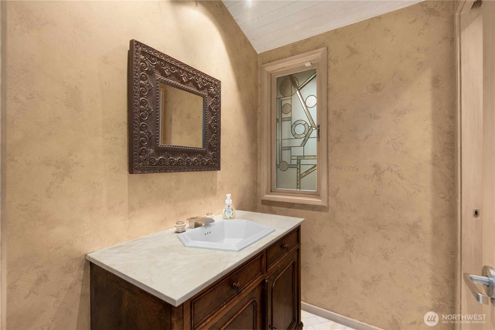 8428 North Mercer Way Mercer Island, WA 98040 - Photo 28 of 40 a bathroom with a sink and a mirror