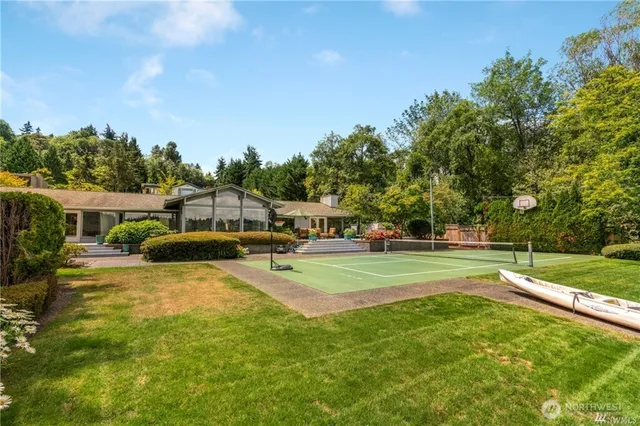 a view of a house with swimming pool and a yard