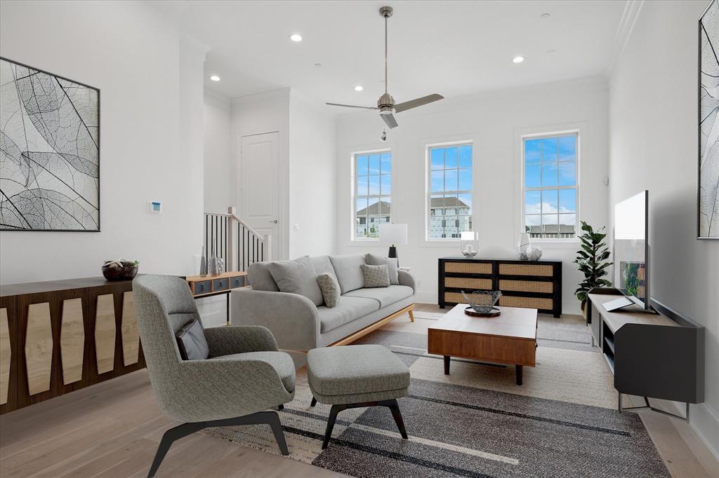 14954 Oak Street Addison, TX 75001 - Photo 3 of 18 a living room with furniture a rug and a chandelier