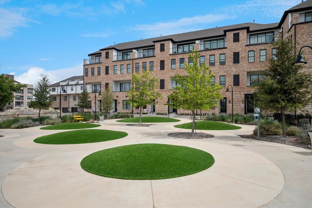 14954 Oak Street Addison, TX 75001 - Photo 7 of 18 a view of a building with a garden and trees
