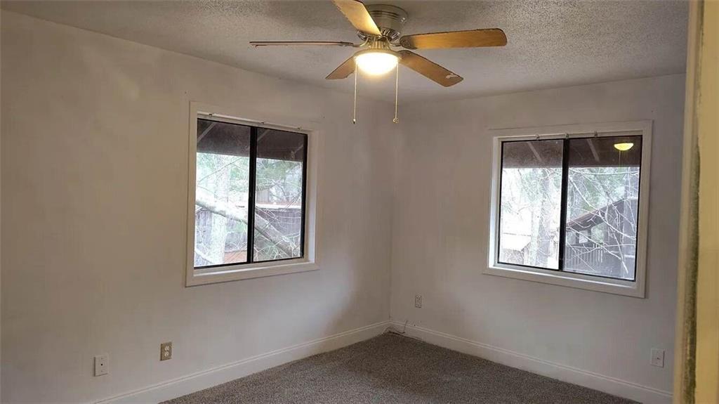 29 Quail Run, Unit B Decatur, GA 30035 - Photo 4 of 16 an empty room with windows and fan
