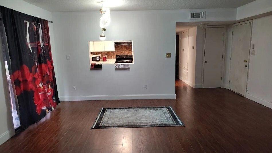 29 Quail Run, Unit B Decatur, GA 30035 - Photo 6 of 16 an empty room with wooden floor and windows