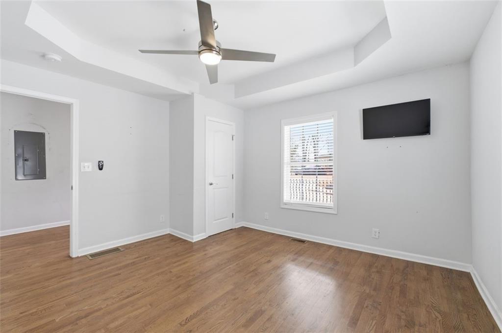 85 Meldon Avenue Southeast Atlanta, GA 30315 - Photo 11 of 39 a view of an empty room with wooden floor and a window