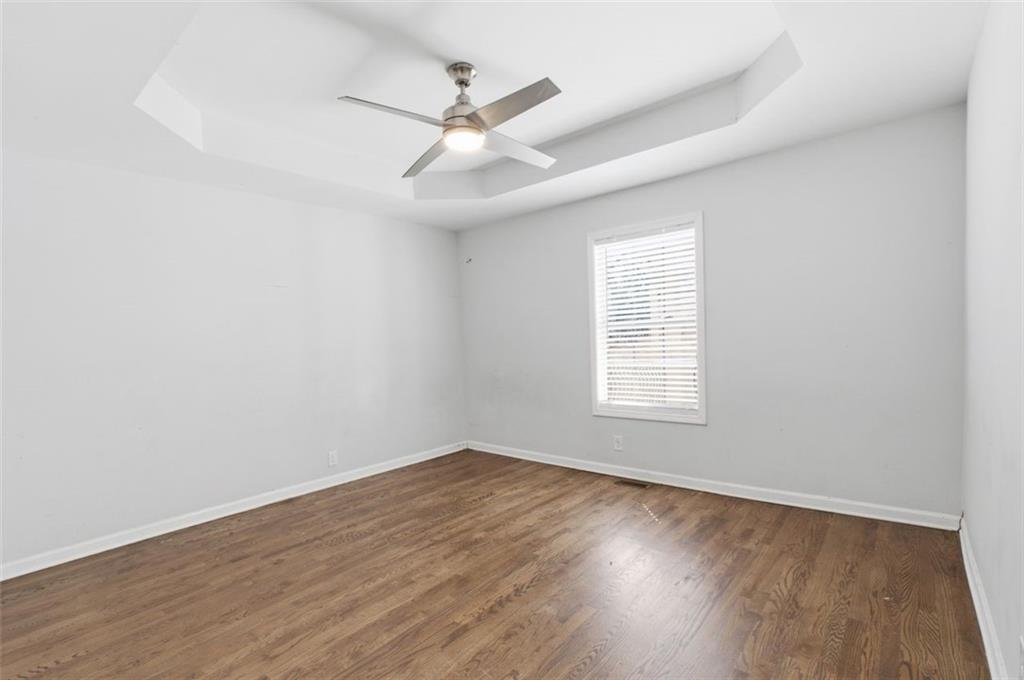 85 Meldon Avenue Southeast Atlanta, GA 30315 - Photo 13 of 39 an empty room with wooden floor fan and windows