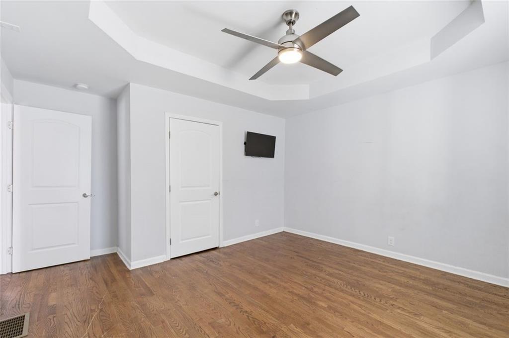 85 Meldon Avenue Southeast Atlanta, GA 30315 - Photo 14 of 39 an empty room with wooden floor and ceiling fan