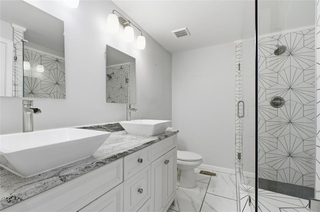 85 Meldon Avenue Southeast Atlanta, GA 30315 - Photo 18 of 39 a spacious bathroom with a granite countertop sink toilet and shower
