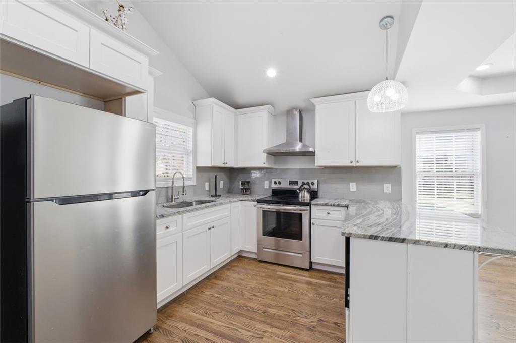 85 Meldon Avenue Southeast Atlanta, GA 30315 - Photo 25 of 39 a kitchen with granite countertop a refrigerator stove top oven and sink