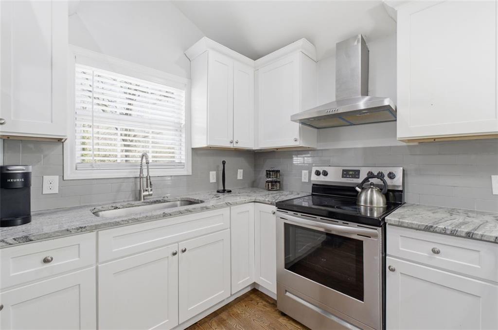 85 Meldon Avenue Southeast Atlanta, GA 30315 - Photo 27 of 39 a kitchen with granite countertop white cabinets and white stainless steel appliances