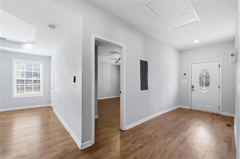 85 Meldon Avenue Southeast Atlanta, GA 30315 - Photo 8 of 39 an empty room with wooden floor and windows