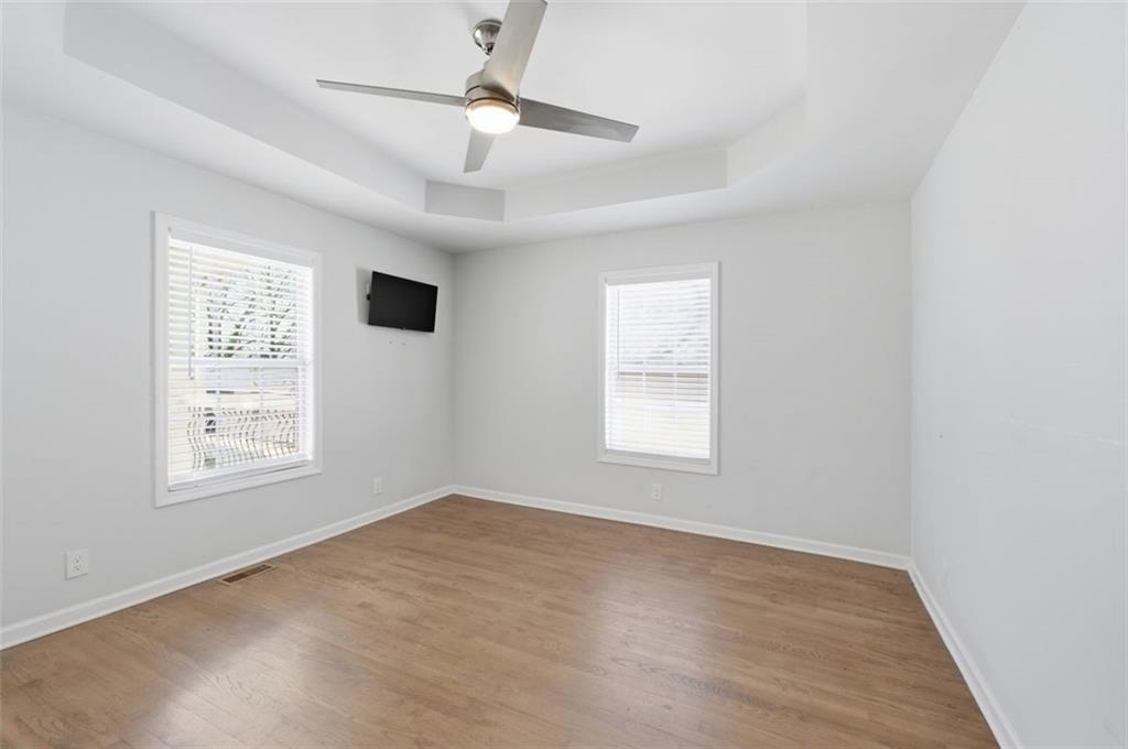 85 Meldon Avenue Southeast Atlanta, GA 30315 - Photo 10 of 39 a view of an empty room with a window and wooden floor