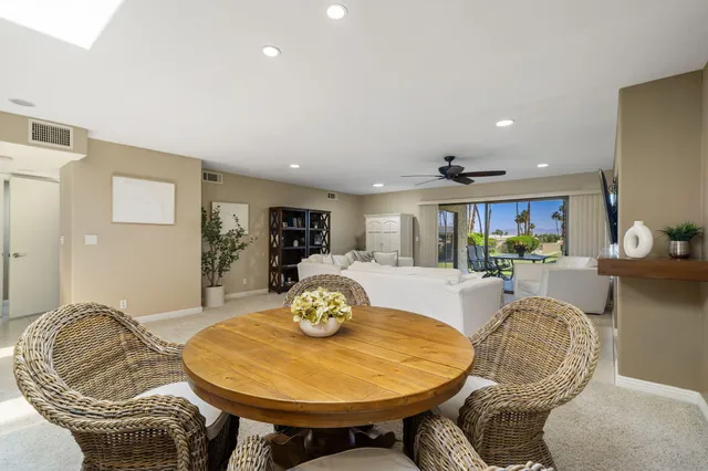 a living room with furniture and a dining table