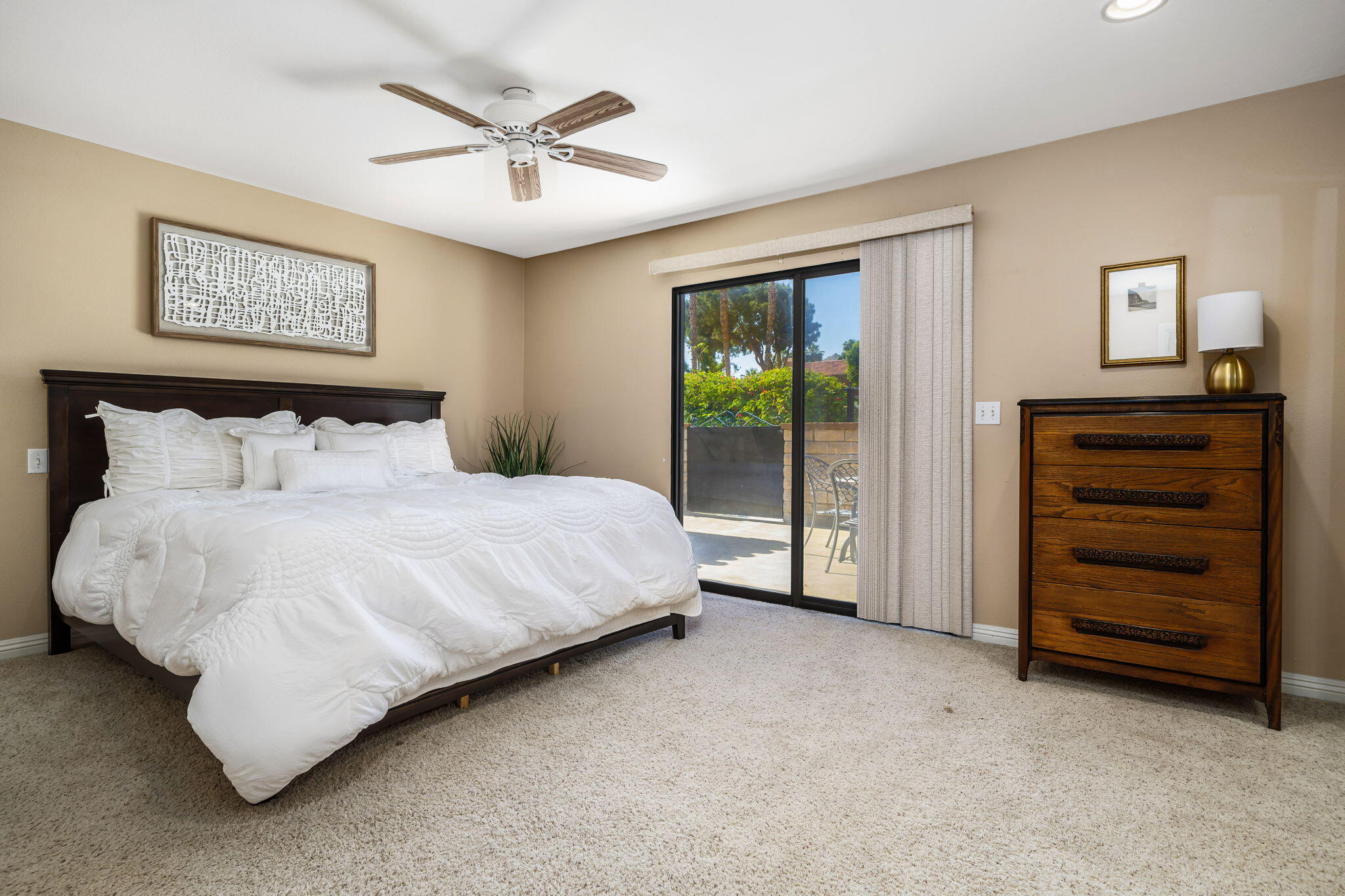 72930 Mesa View Drive Palm Desert, CA 92260 - Photo 27 of 40 a spacious bedroom with a bed and a ceiling fan