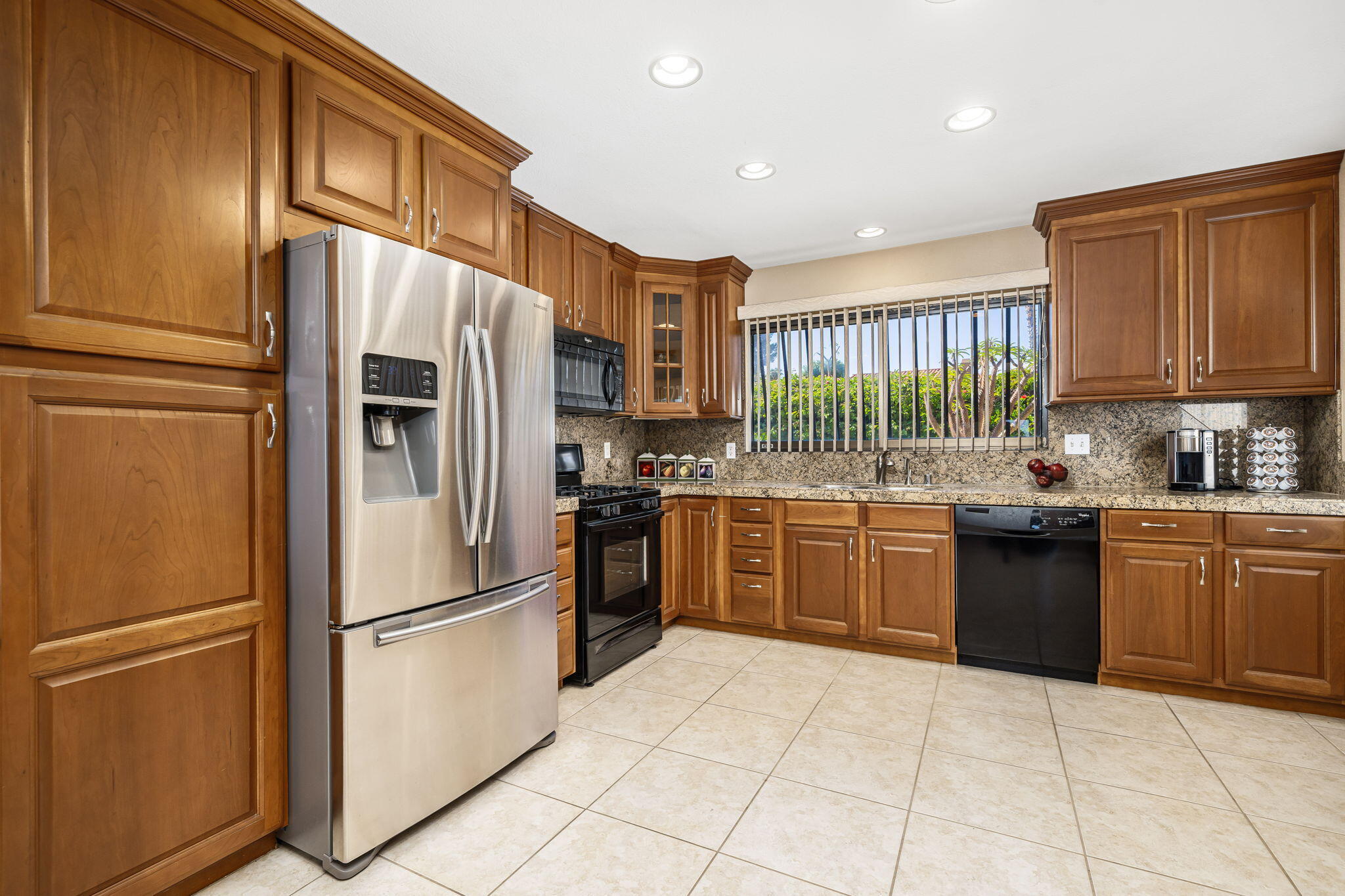72930 Mesa View Drive Palm Desert, CA 92260 - Photo 3 of 40 a kitchen with stainless steel appliances granite countertop a refrigerator sink and stove