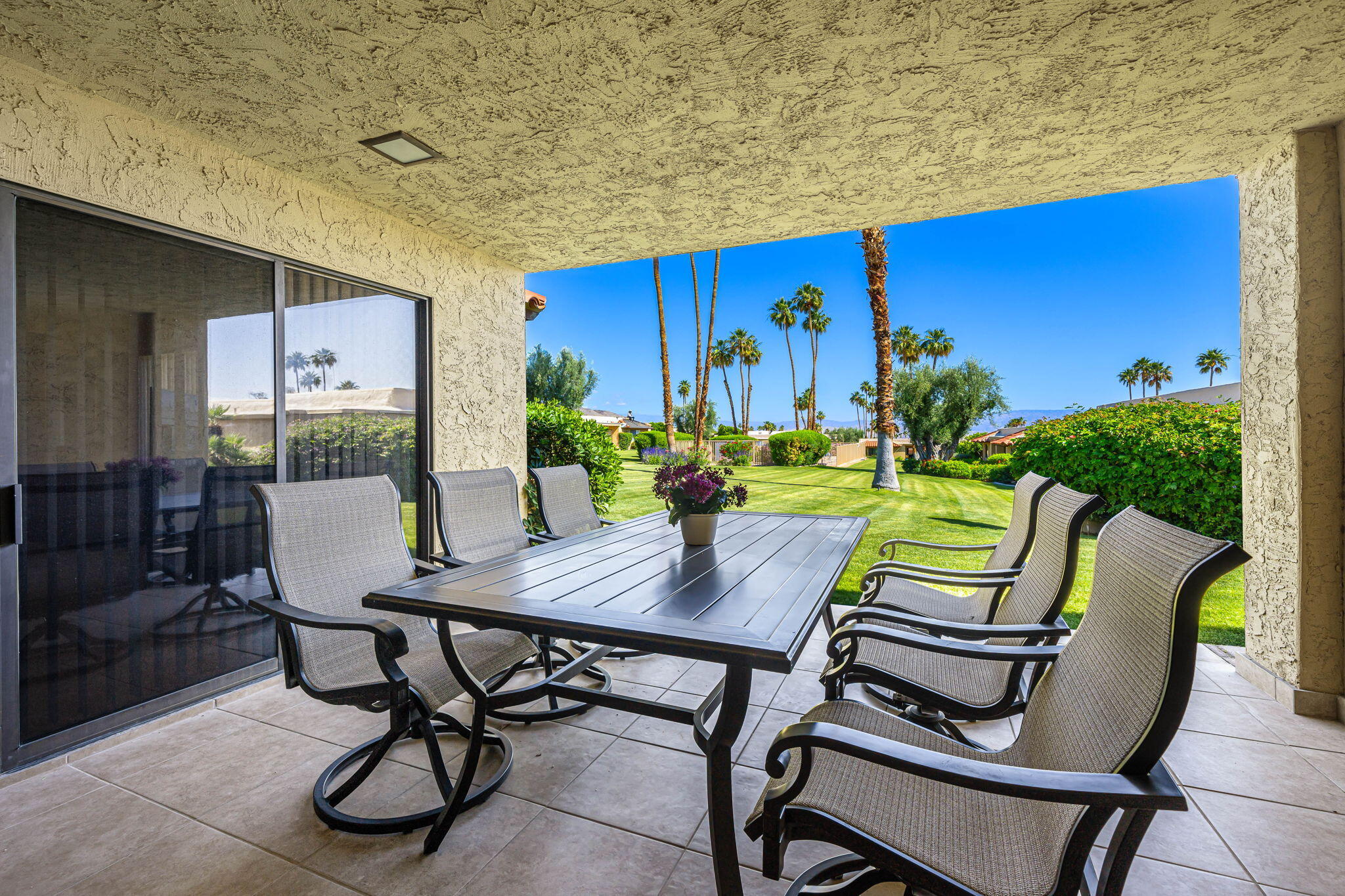 72930 Mesa View Drive Palm Desert, CA 92260 - Photo 34 of 40 a view of a dining room with furniture and a potted plant